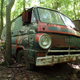 A Dodge A100, one off the last Detroit cab-over-engine vans. This example sat in a line of other commercial vans from the same era, all showing multiple paint colors from their various liveries.